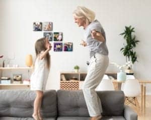 grandma and kid jumping on couch